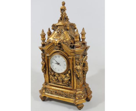 A modern mantel clock, in the rococo style, surmounted by a semi-clad figure of a lady above a 9cm dia. dial in a highly elab