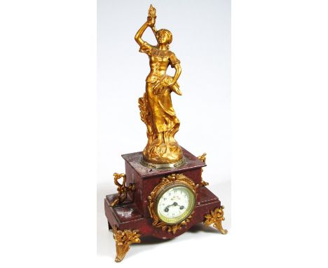A late 19thC mantel clock, the 8cm dia. Arabic dial surmounted by a gilt metal figure entitled Moisson Pr. Ruchot, on a plint
