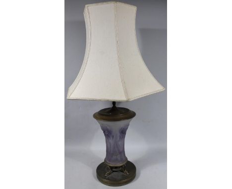 A mid 20thC amethyst glass and metal table lamp, the inverted body raised with flowers in purple and frosted glass with a pie