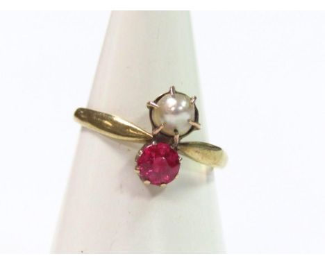 A ladies dress ring, claw set with pearl and pink stone, the plain shank marked 333, size K, in an associated box.