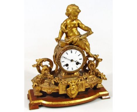 A late 19thC gilt metal mantel clock, the 10cm dia. Roman numeric dial with eight day movement surmounted by a semi-clad cher