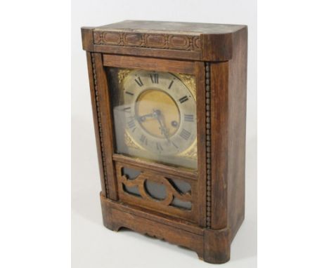 An early 20th century oak cased mantel clock, the Roman numeric dial, before a 16cm wide back plate and eight day key wind mo