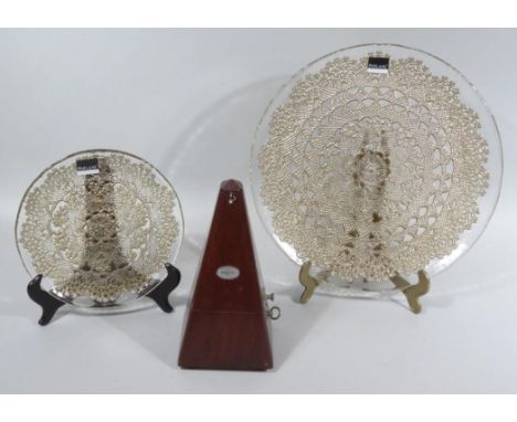 A 20thC Paquet metronome, of tapering outline, 25cm high and two graduated Parlane glass dishes. (3)