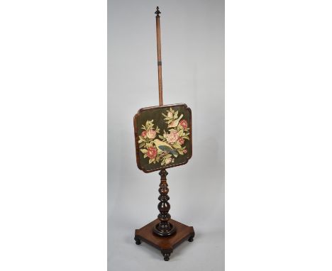 A Mid 19th Century Pole Screen in Mahogany with Tapestry Panel Decorated with Bird and Roses, Square plinth Base and Four Tur