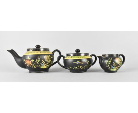 A Newport Pottery Co. Three Piece Tea Service Decorated with Birds and Flowers on Black Ground