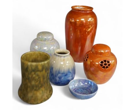 A group of six Ruskin pottery items, comprising an orange lustre vase, similar jar and cover, another lustre jar and cover, v