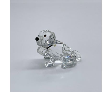 Part of the Pets Corner. A clear crystal dog with colored eyes and black crystal eyes. Around the puppy's neck is a elastic b