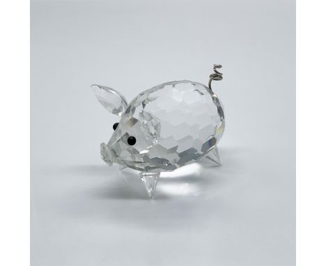 An adorable pig made from clear crystal and black eyes. He has a metal wire curly tail. Swarovski swan mark. This item has it