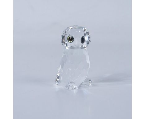 An adorable tiny owl standing cautiously, with wide, expressive melon-colored eyes. Swarovski backstamp. This item has its or