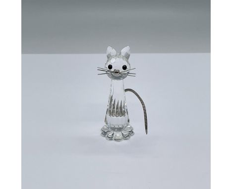 Tall sitting crystal cat with silver colored metal whiskers and flexible, serpentine tail. This item has its original box. Me