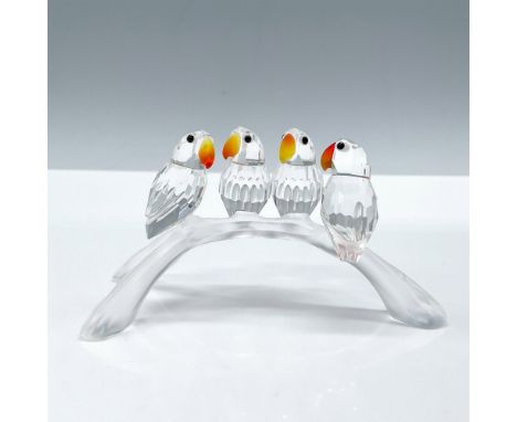 Lead crystal four baby lovebirds sitting on a branch that were part of the Feathered Beauties collection. They sit on a three