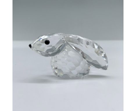 A cute, tiny rabbit with big floppy ears, sitting on its bottom and adorned with black crystal eyes. Swarovski backstamp. Thi