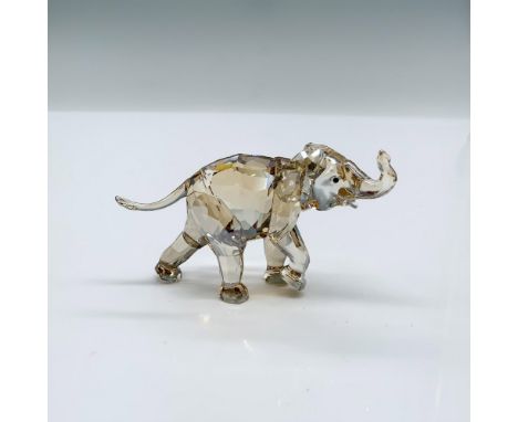 The adorable Young Elephant is created in the Crystal Light Sand color with a Swarovski acid mark. Its trunk is turned up and