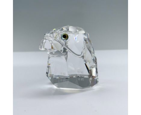 The head of a falcon with a narrow facet around the face, showcasing melon colored eyes. Swarovski backstamp. Swarovski backs