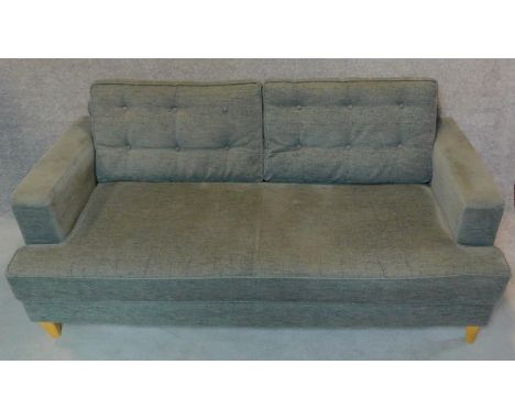 A two seater sofa by Heals (Mistral) in grey buttoned upholstery on tapered block feet. H.85 W.182 D.87cm