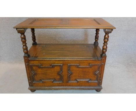 A mid 20th century oak Jacobean style monk's bench with sliding metamorphic back. H.78 W.93 D.46cm 