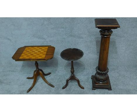 A Georgian style tilt top table with chess board inlay, another wine table and a torchere. H.91cm (tallest) 