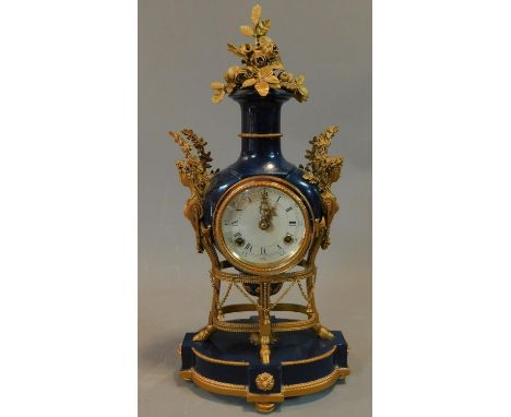 A blue ceramic and gilt metal French style mantel clock, white ceramic dial with laurel and caryatid decoration. H.42cm 