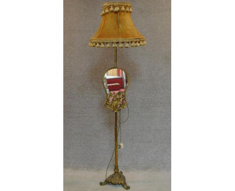 A gilt metal Rococo style standard lamp fitted adjustable glass panel. H.170cm 