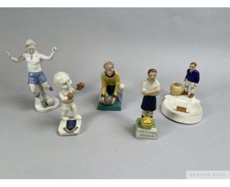 A crested Arcadian ash tray and match holder modelled as a Chelsea footballer, a continental figure of a footballer, another 