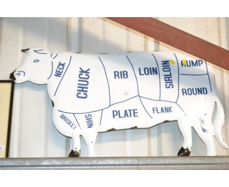 An enamel cow sign 