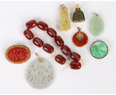 A collection of Asian jewellery, to include a Chinese lacquer brooch, jade pendants and hardstone pendants and a bead necklac