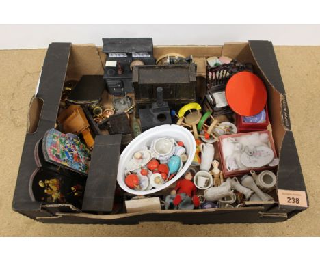 A small box of mixed vintage dolls house furniture including metal stoves, a wooden cupboard and ceramic part tea sets