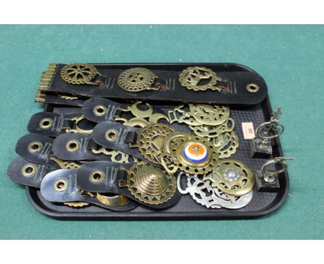 Various vintage horse brasses, some mounted on leather
