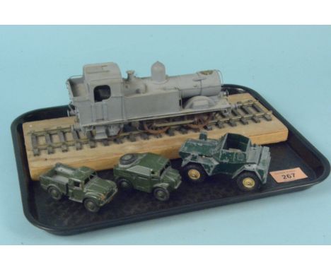 A vintage clockwork train that has been over painted in grey plus three Dinky military vehicles (all playworn)