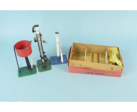 Four vintage Hornby tin plate accessories including signal, water tower, height gauge and a boxed level crossing