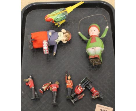 A vintage Mikuni clockwork tin plate budgerigar toy, a clockwork monkey and skipping figure plus some Britains lead guardsmen