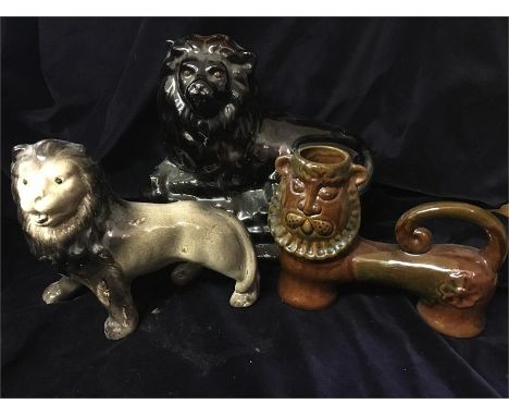 A selection of three ceramic lions