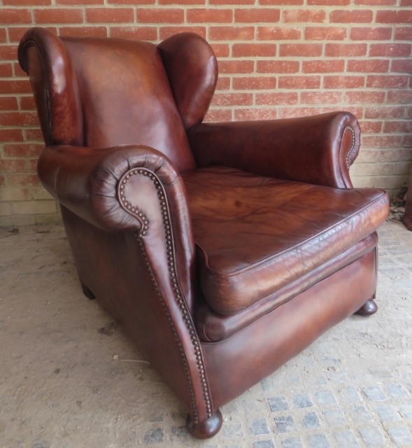 A very clean 19th century brown leather fireside chair with brass stud