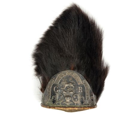 A 1768 pattern grenadier fur cap,  red cloth back with white braid trim and tassels, blackened white metal die struck, ear to