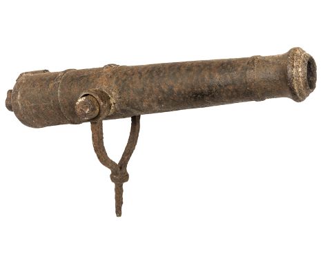 An early 19th century ship’s iron swivel cannon from a merchantman, 31” overall, cast between the trunnions with a crown over