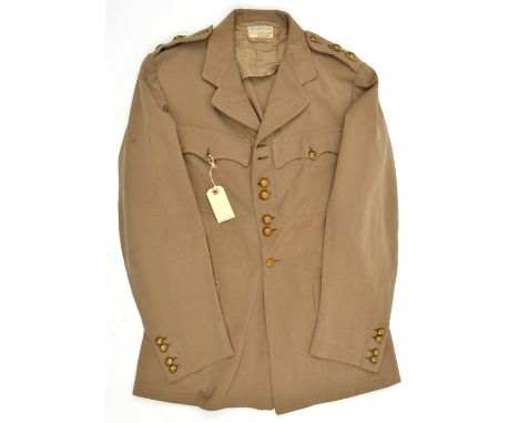 A Lieutenant’s khaki 4 pocket tropical tunic of the Coldstream Guards, buttons in pairs to chest and cuffs, shoulder straps w