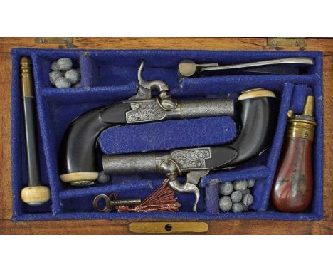 1.25inch etched damascus turn-off barrels, border and foliate engraved actions, folding triggers, ebonised wooden butts with 