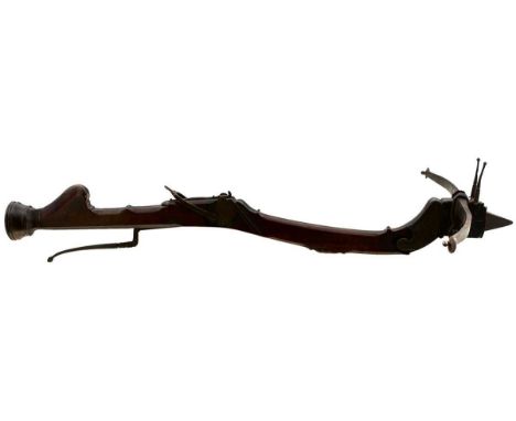 the 27inch span steel struck with a clear armour of spade form, the curved stock carved with geometric designs, the tiller wi