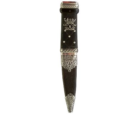 10cm fullered blade with faceted back edge, characteristic white metal mounted hilt set with a faceted coloured stone, carved