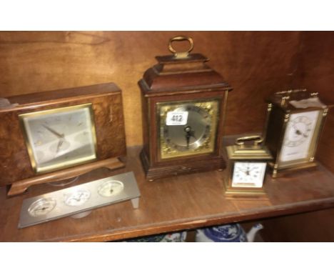 SHELF OF VARIOUS CLOCKS