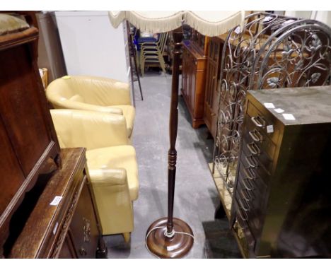 Walnut standard lamp with turned stem. All electrical items in this lot have been PAT tested for safety and have passed. This
