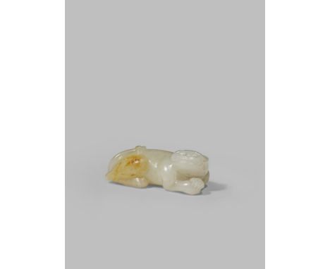 A CHINESE PALE CELADON JADE CARVING OF A TIGER QING DYNASTY OR LATER Recumbent with one front paw placed on top of the other,
