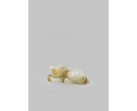 A CHINESE CELADON JADE MODEL OF A LION DOG MING DYNASTY OR LATER Crouching with his head turned to sinister and with his fron