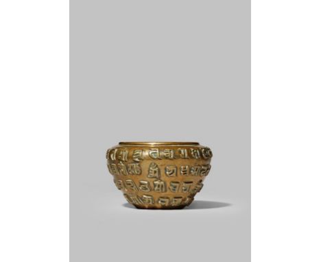 A SMALL TIBETO-CHINESE BRONZE BOWL 19TH CENTURY Cast in relief with four bands of lança characters, 9.8cm.