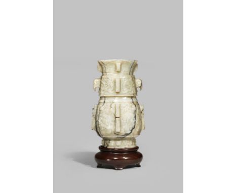 A CHINESE MOTTLED GREY JADE ARCHAISTIC VASE MING DYNASTY The stone with dramatic black vertical striations, the body carved i