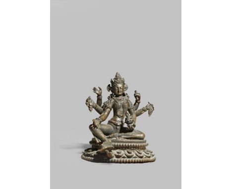 A NEPALESE GILT BRONZE SEATED FIGURE OF VASUDHARA 10TH/11TH CENTURY The multi-armed goddess sits wearing an elaborate headdre