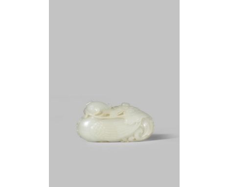 A LARGE CHINESE PALE CELADON JADE CARVING OF A PHOENIX QING DYNASTY Crisply carved sitting facing forward with its feet neatl