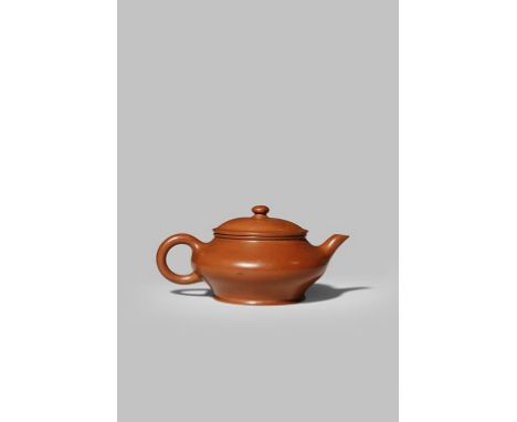 A SMALL CHINESE YIXING TEAPOT EARLY 18TH CENTURY With a compressed circular body and simple loop handle, the base with a six 