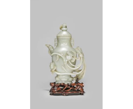 A LARGE CHINESE CELADON JADE EWER AND COVER QIANLONG 1736-95 The baluster-shaped body raised on a double lotus foot, the hand