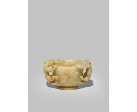 A CHINESE CELADON JADE TWO-HANDLED CUP MING DYNASTY The U-shaped bowl carved with two sinuous chilong climbing to the rim, ea